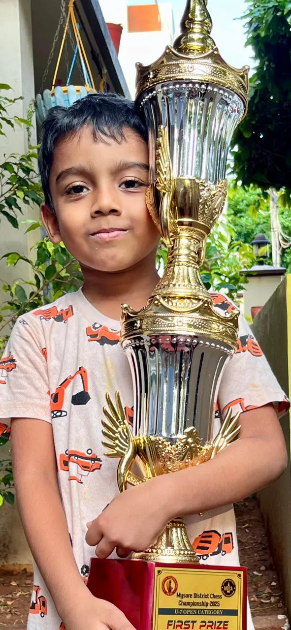 Gahan holding the First Prize trophy at Mysore District Chess Championship 2025
