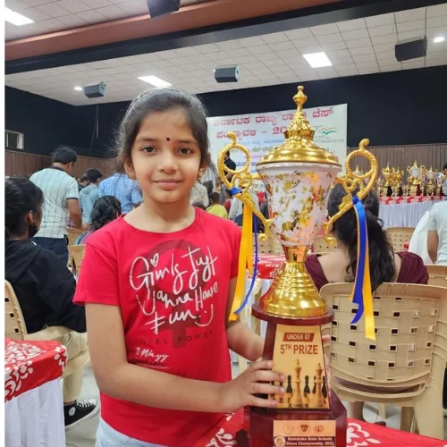 Saanvika holding her medal after a chess tournament victory